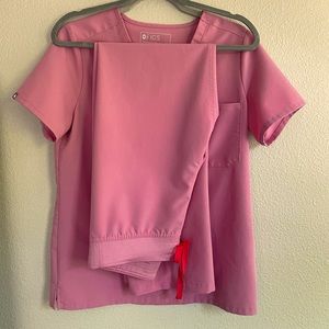 Pair of FIGS Scrubs in mauve.